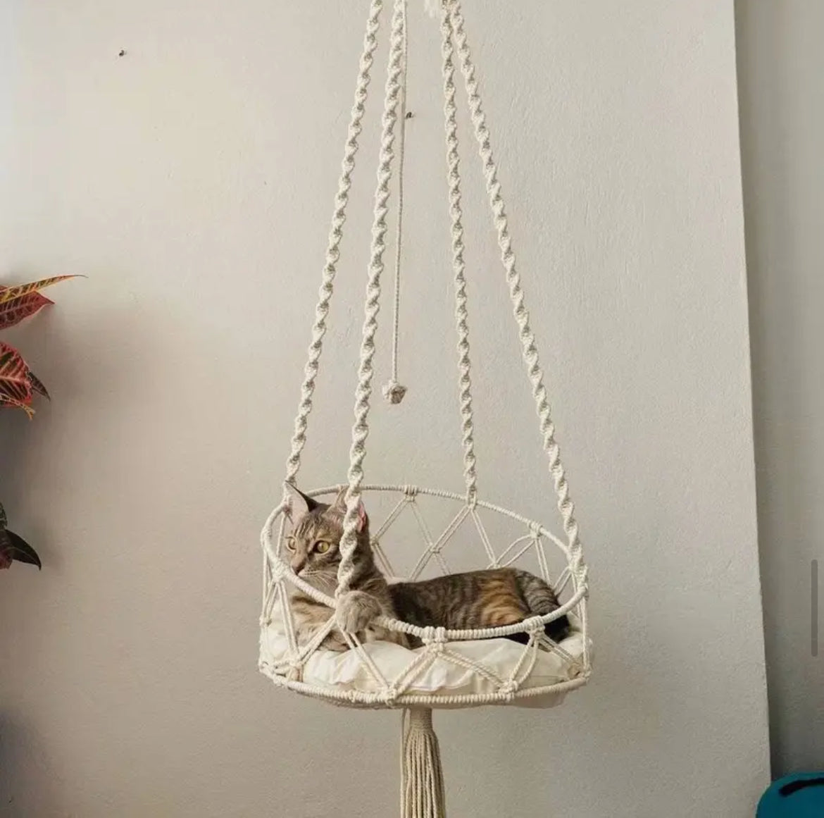 Handwoven bohemian hammock hanging indoors.