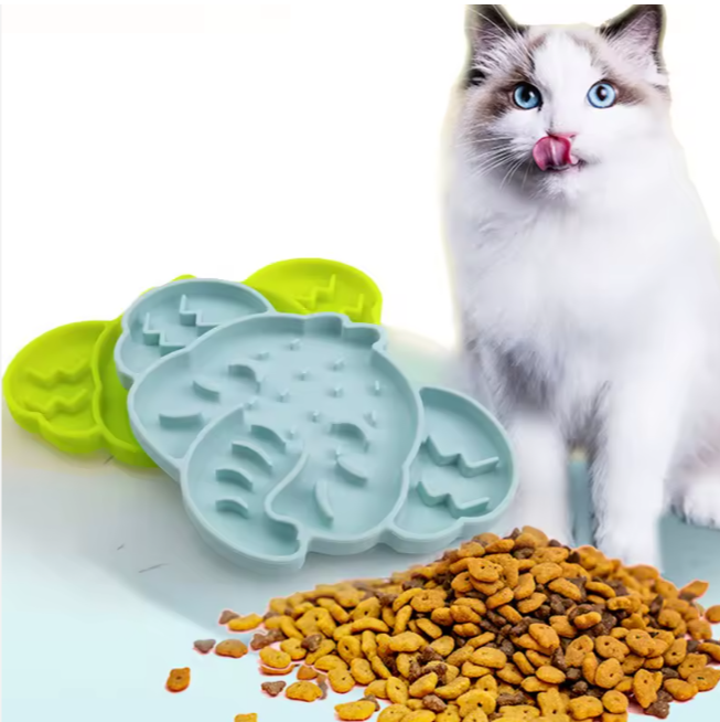 Cat eating next to elephant-shaped silicone slow feeder