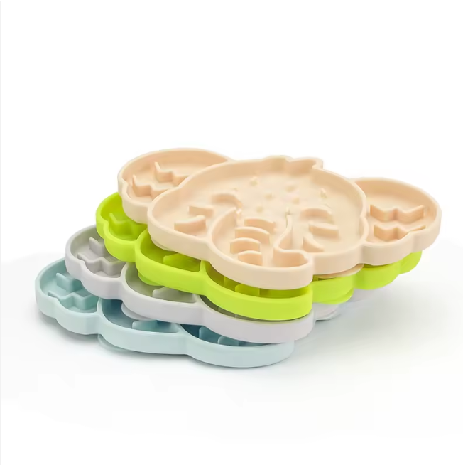 Stack of elephant-shaped silicone slow feeder mats in assorted colours