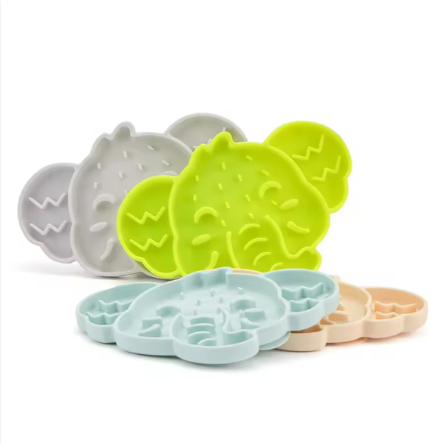 Stack of elephant-shaped silicone slow feeder mats in assorted colours.