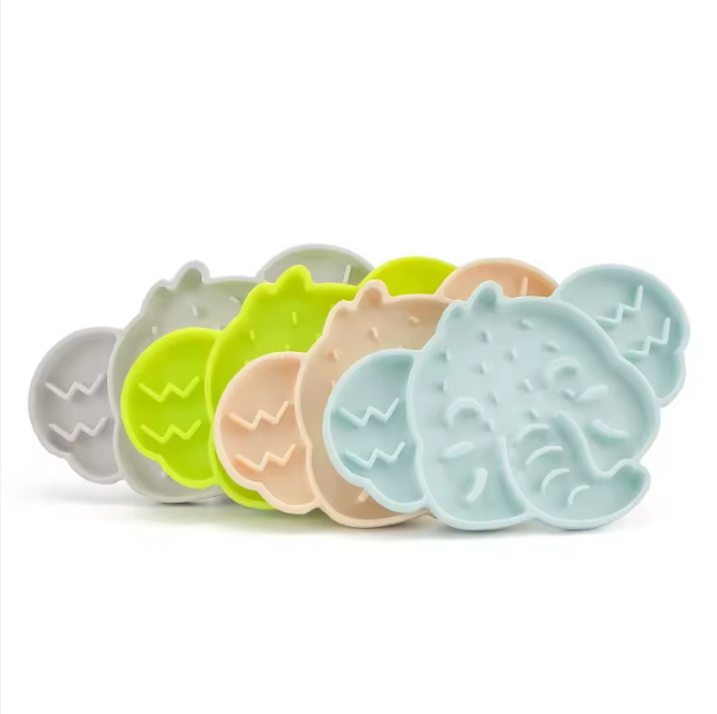 Stack of elephant-shaped silicone slow feeder mats in assorted colours