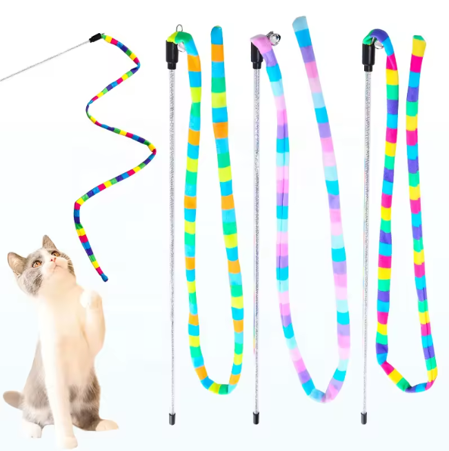 A cat playing with a colourful cat teaser with a glitter-infused wand and colourful linen teaser.