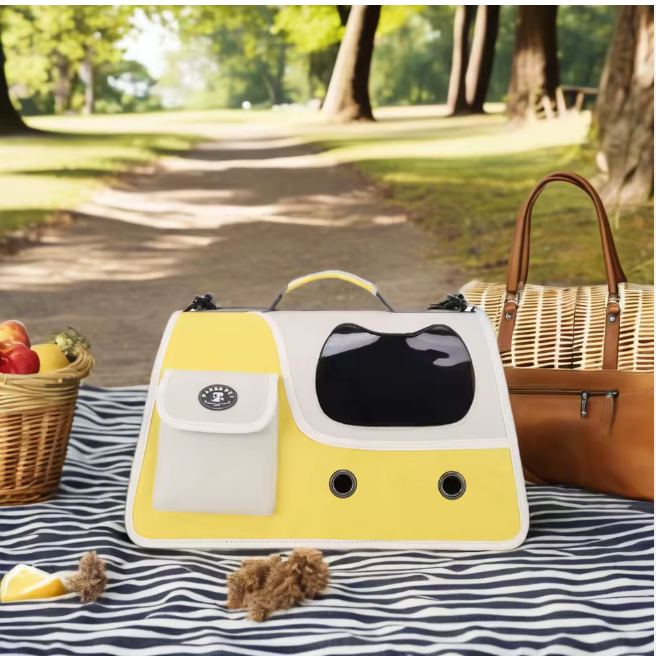 Yellow cat carrier displayed outdoors on picnic blanket