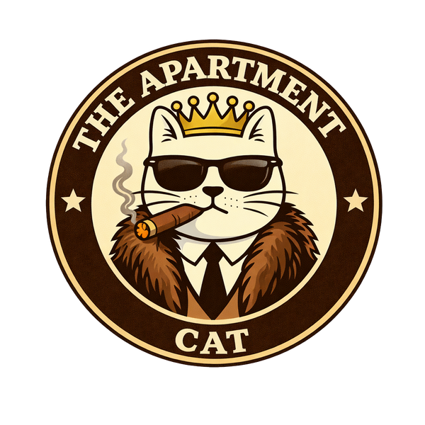 Logo of The Apartment Cat featuring a white cat wearing a crown, sunglasses, and a fur coat, holding a cigar, inside a circular emblem.