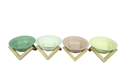 Omertà ceramic cat bowl with bamboo stand, tilted design. In sage green, cream, pink and yellow. 
