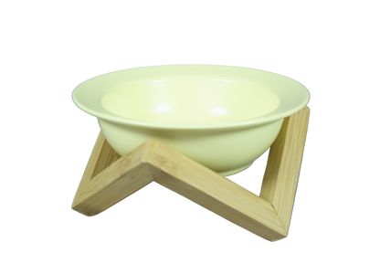 Yellow elevated ceramic cat bowl on bamboo stand.