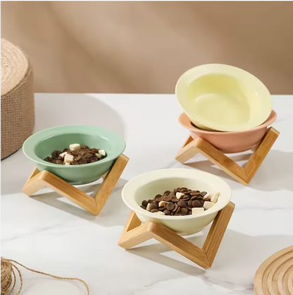 Omertà ceramic cat bowl with bamboo stand, tilted design.